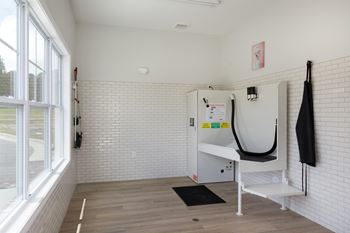 A white room with a bench and a hanger.